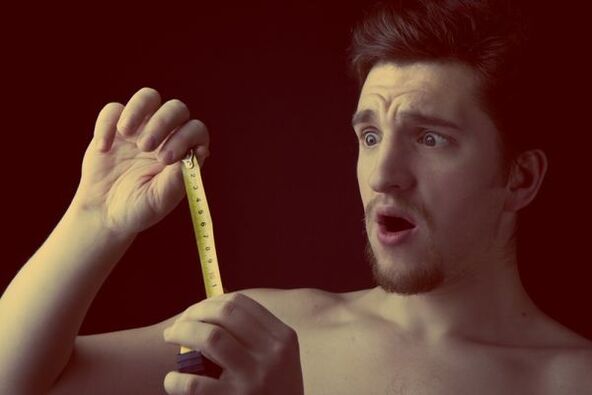 a man measures the size of his penis before an enlargement operation